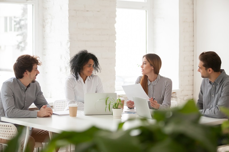 team discussing document papers on desk