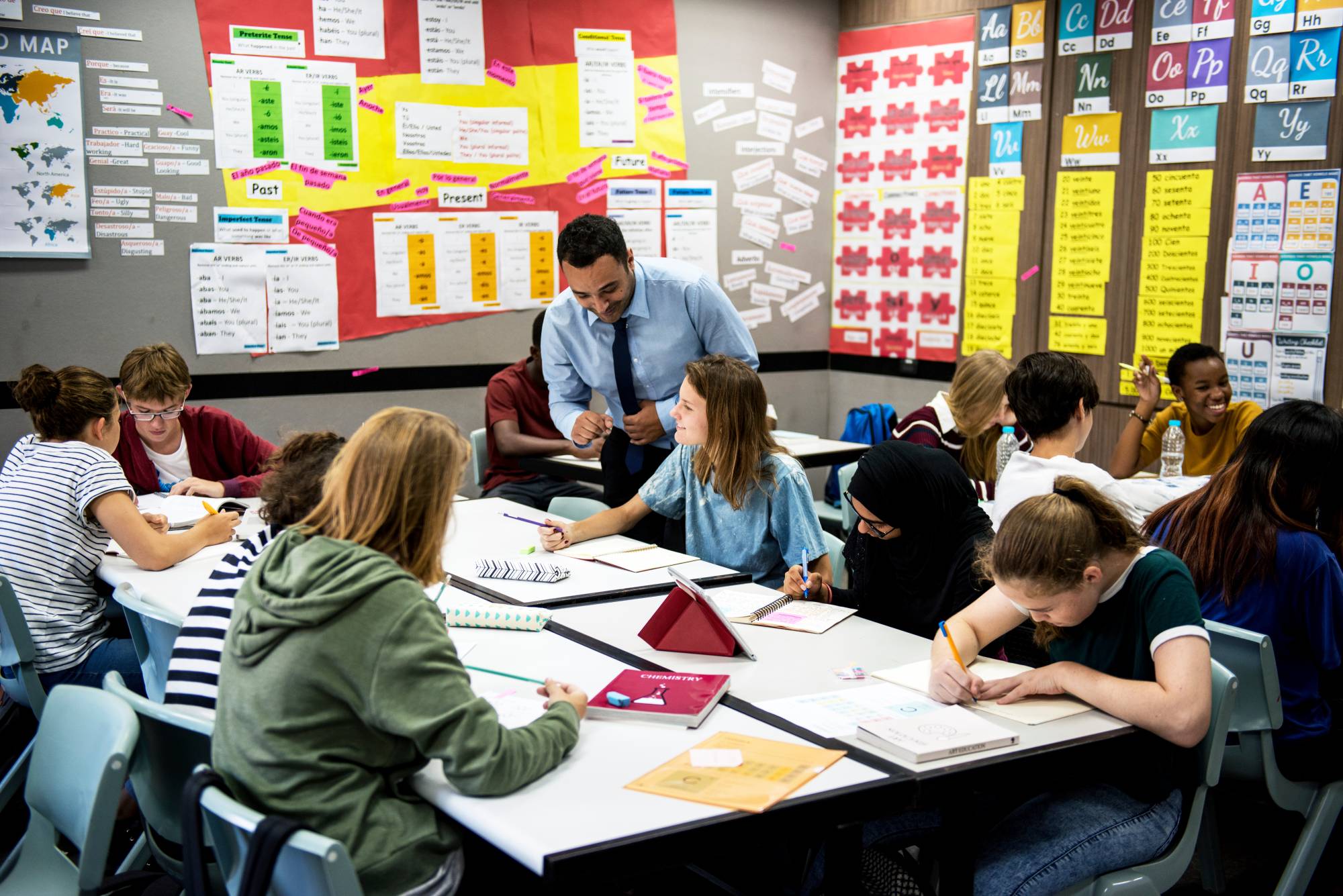 A middle school teacher monitors students who are in groups, demonstrating the Marzano Element “Organizing Students to Interact with Content” in the domain of effective classroom instruction, as part of the Focused Teacher Evaluation Model.